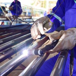 welding iron spark fire hot steel with power GMAW welder and protective gear